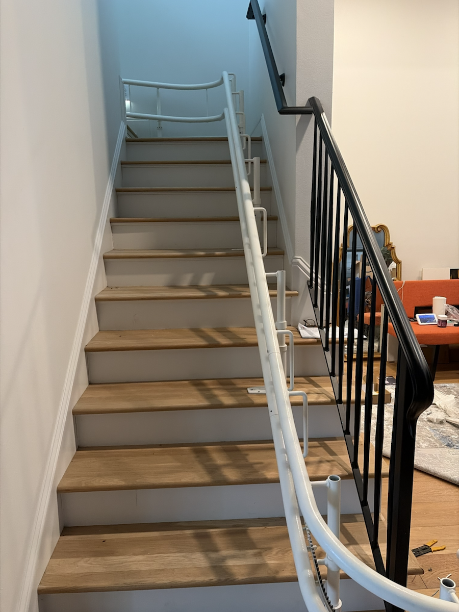 Curved stair lift installed along a residential staircase.